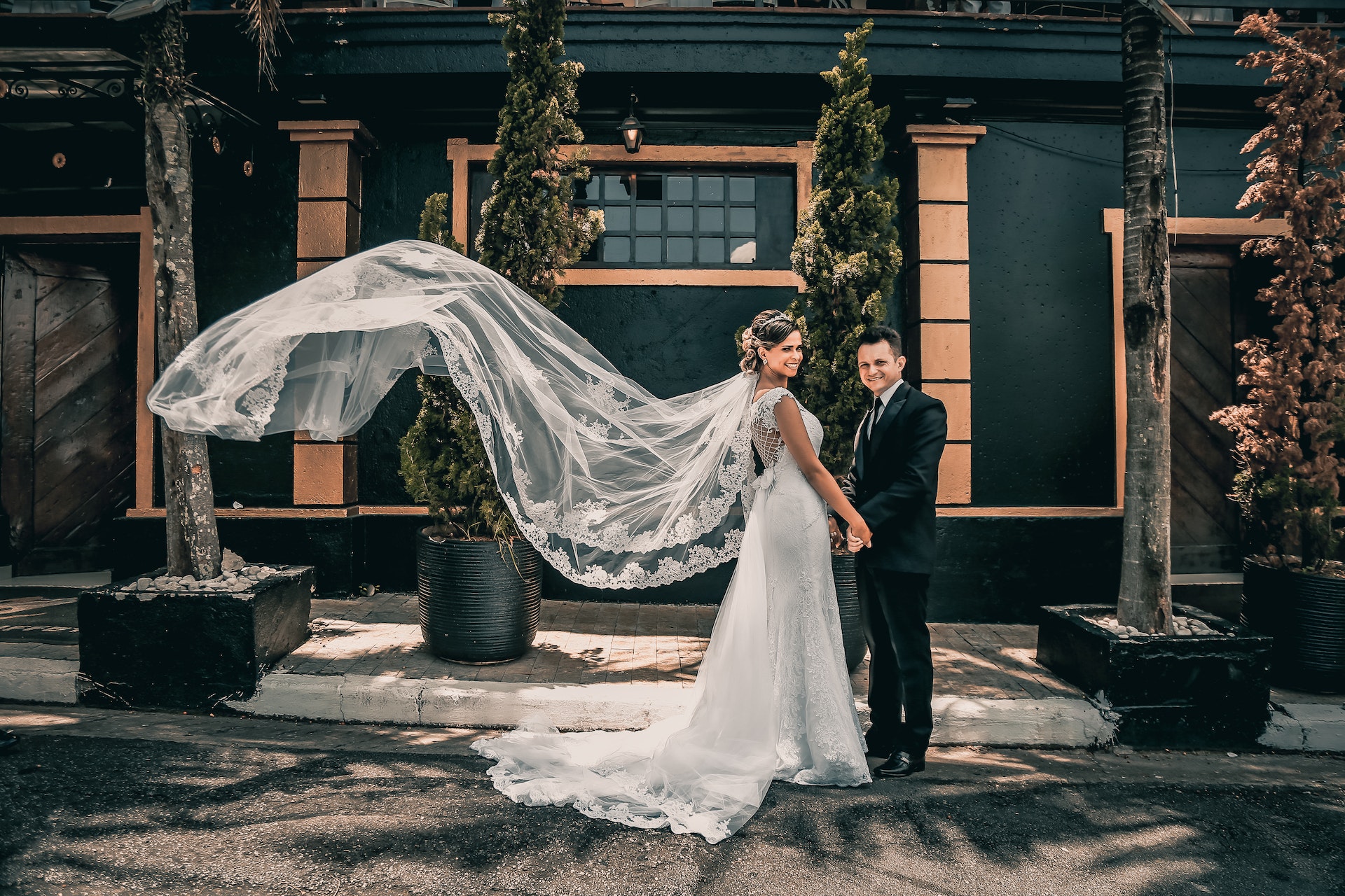 just married couple on the street, the wife is holding her husband's hand